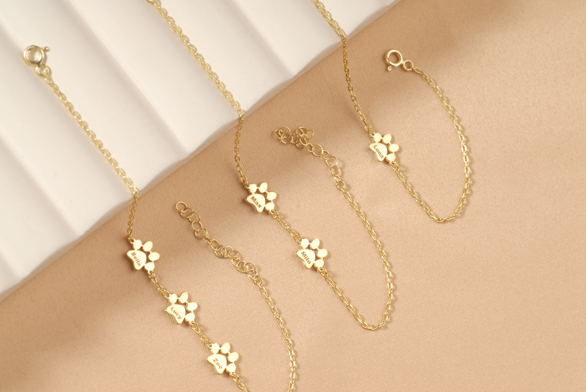 Close-up of a pet name engraved on a petite paw charm