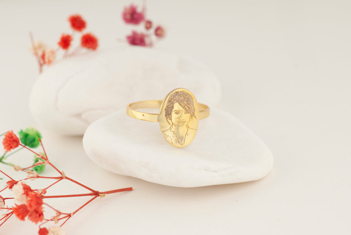 Close-up of a custom portrait engraved on an oval ring