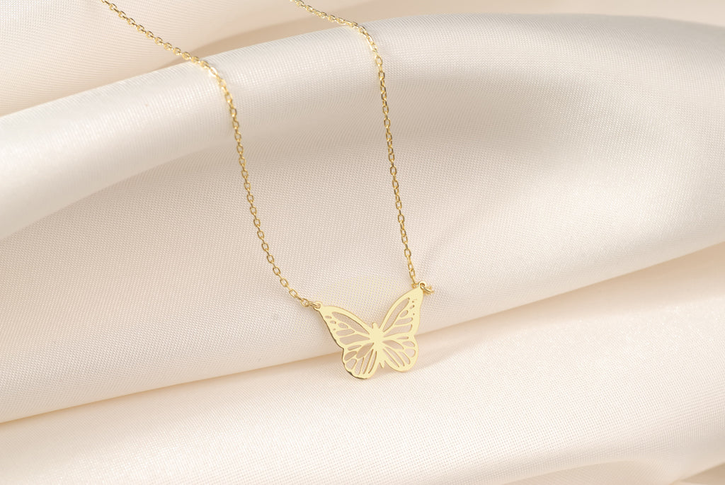 Close-up of the delicate flying butterfly pendant