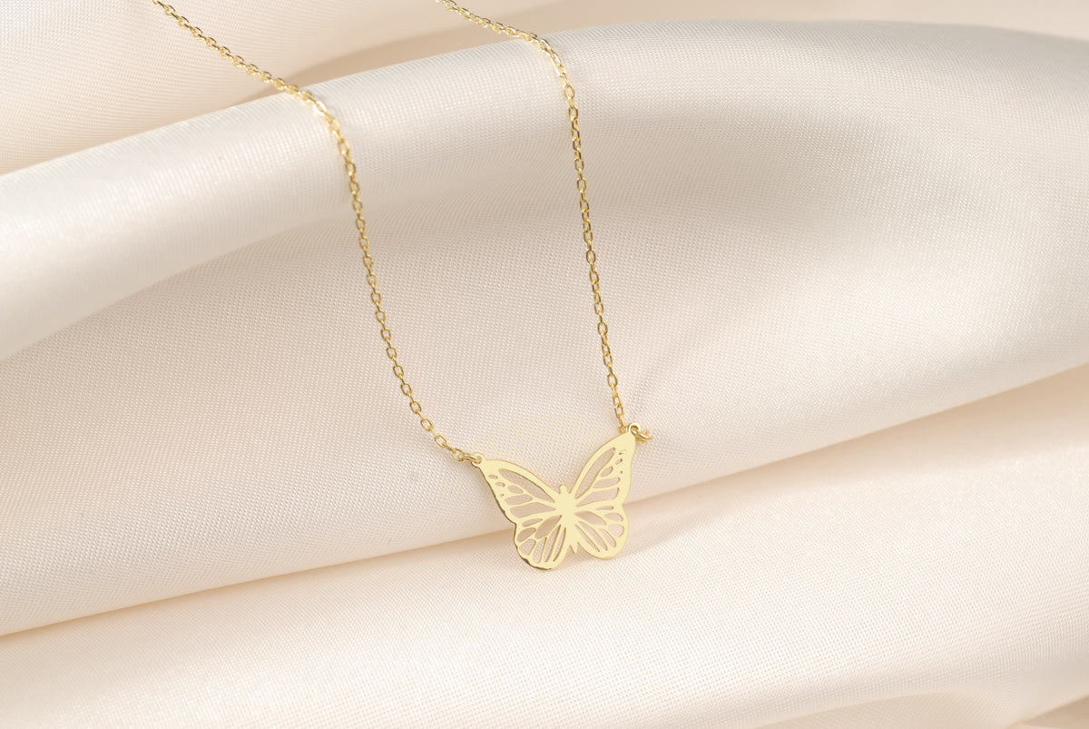 Close-up of the delicate flying butterfly pendant