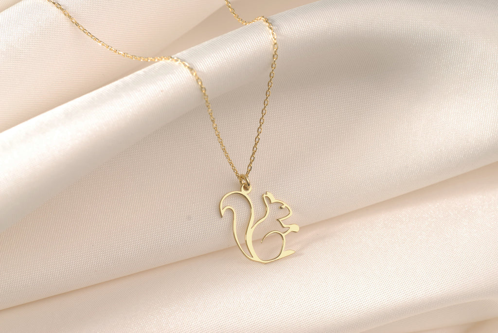 Close-up of an openwork gold squirrel pendant