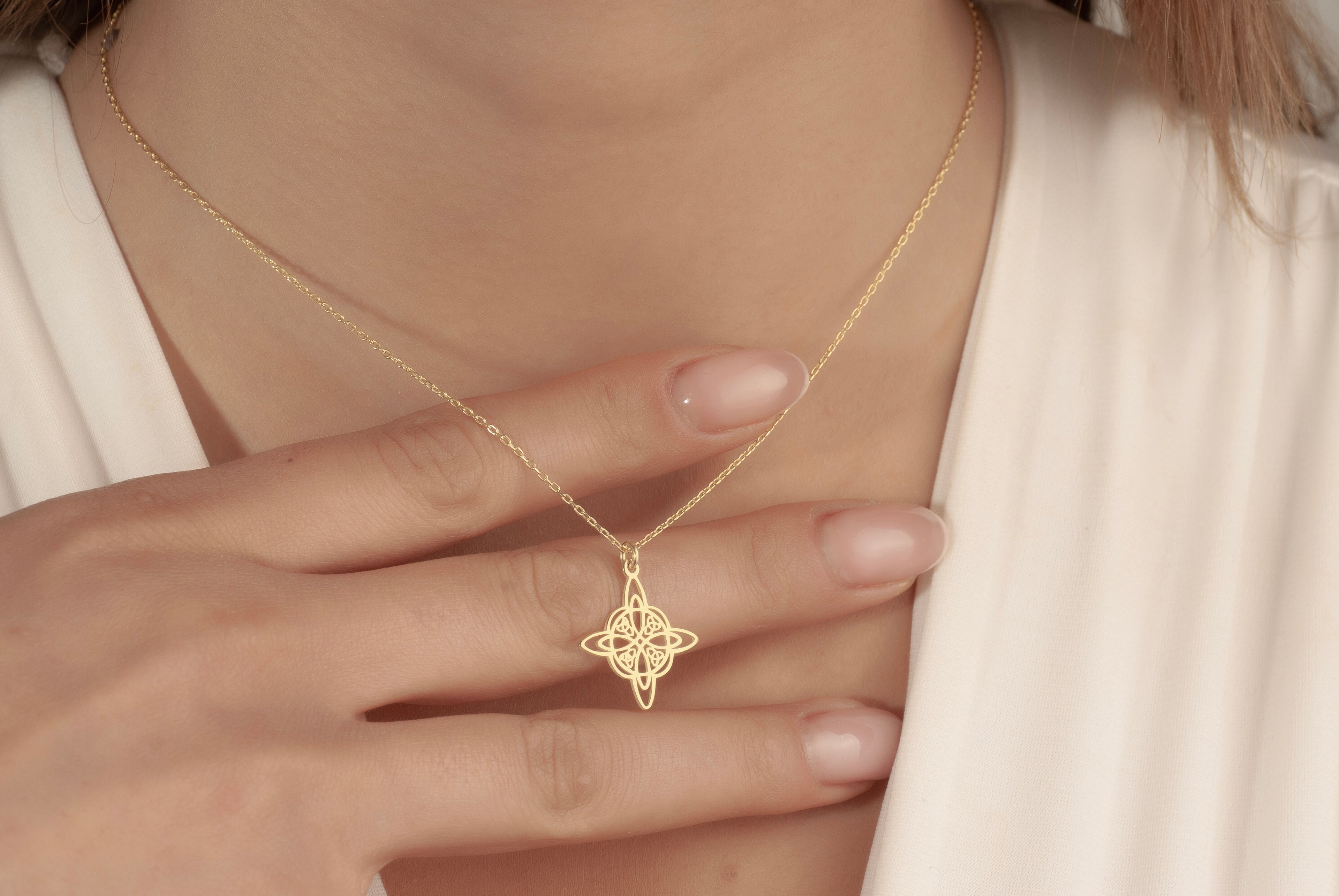 Dainty Celtic knot necklace worn by a woman