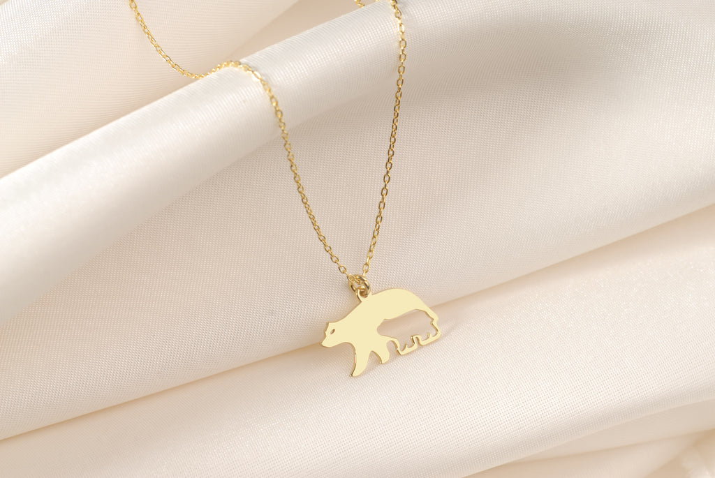 Close-up of a Mama Bear pendant with baby bear silhouette