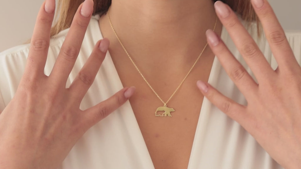 Gold Mama Bear Necklace worn by a woman