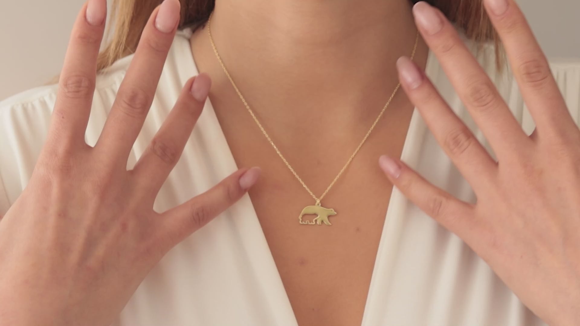 Gold Mama Bear Necklace worn by a woman