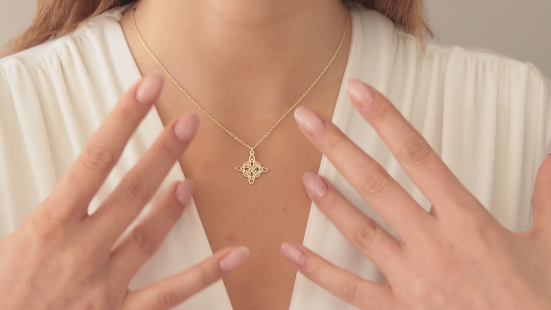 Dainty Celtic knot necklace worn by a woman