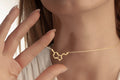Gold serotonin molecule necklace with a delicate cable chain