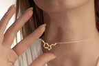 Gold serotonin molecule necklace with a delicate cable chain