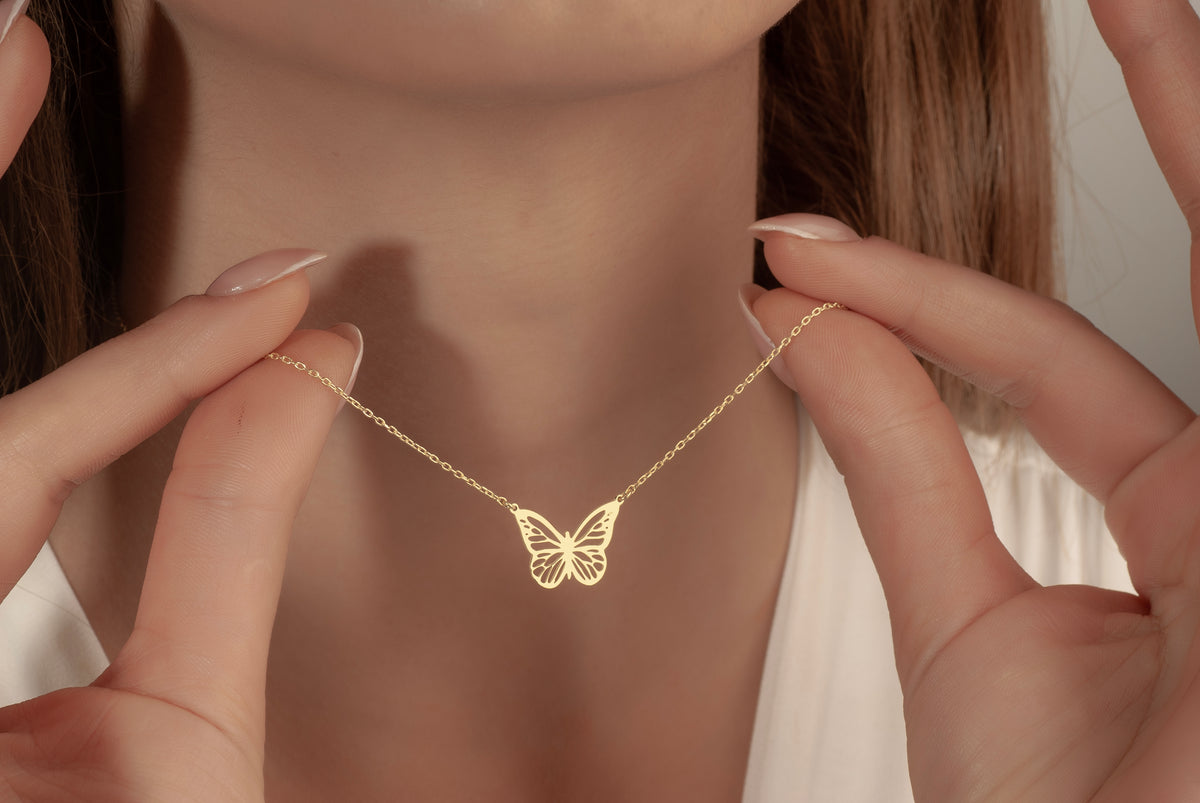 Dainty gold butterfly necklace with a delicate cable chain