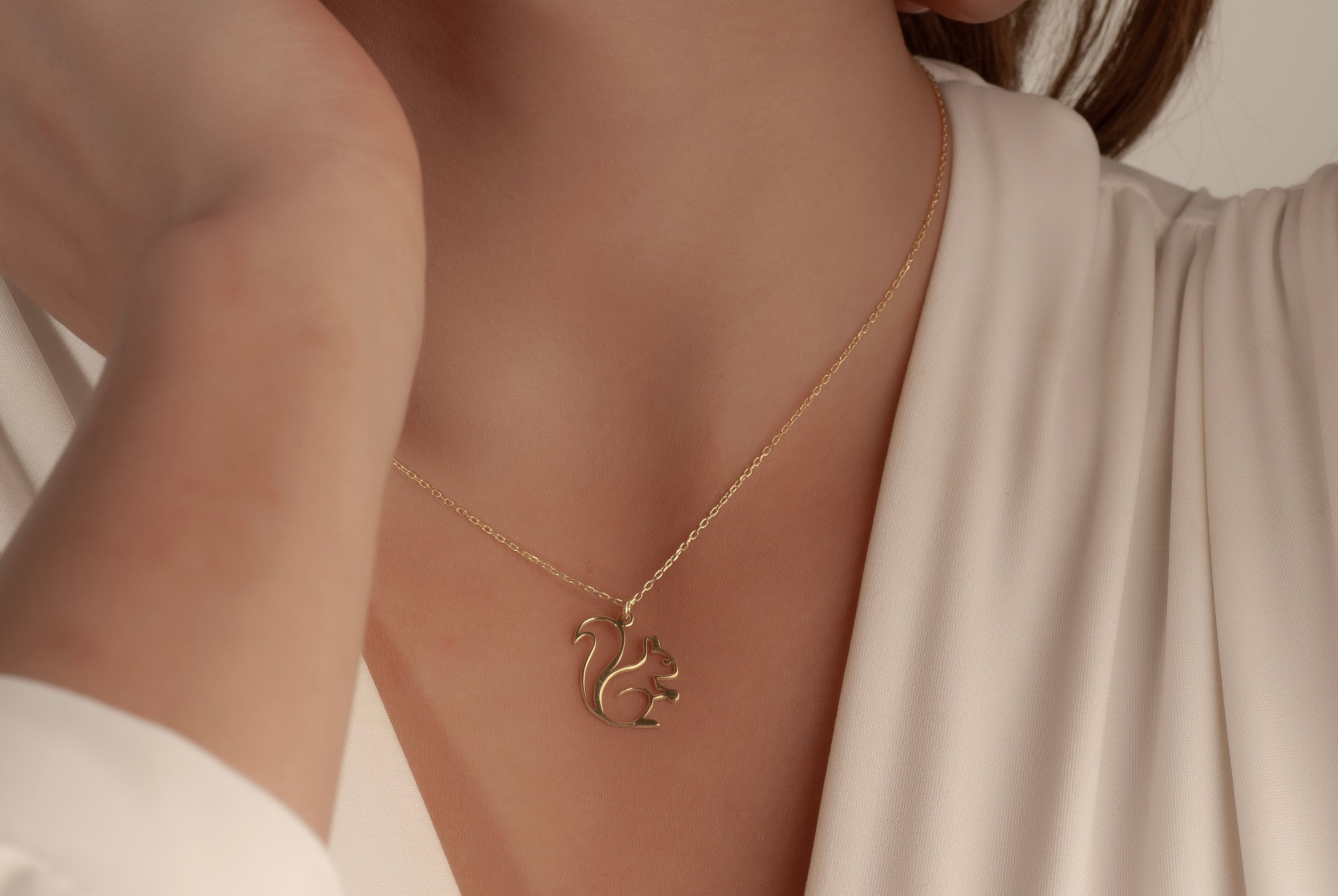Delicate chain and pendant connection on squirrel necklace